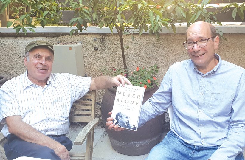 Natan Sharansky (left) and Gil Troy receive the first copies of their book ‘Never Alone: Prison, Politics and My People.’ (photo credit: LARISSA RUTHMAN)