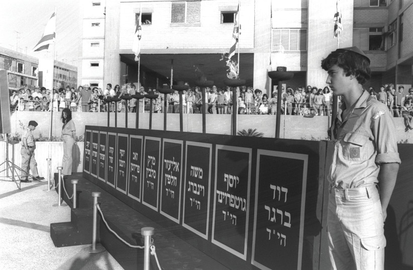 SCOUTS GUARD torches above the names of the 11 Israeli athletes murdered at the 1972 Summer Olympics in Munich by terrorists from the Black September movement, at the memorial ceremony in Tel Aviv. (credit: YA’ACOV SA’AR/GPO)