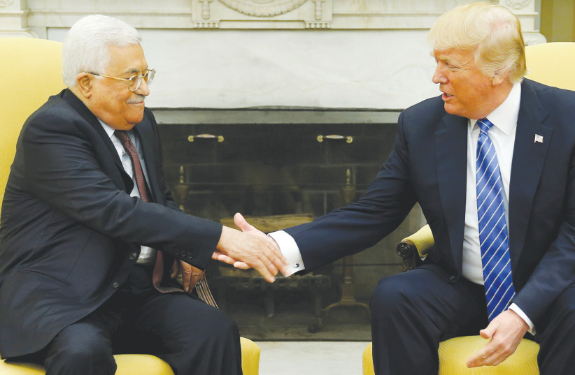 US PRESIDENT Donald Trump welcomes PA President Mahmoud Abbas in the Oval Office of the White House in Washington, in 2017. (photo credit: JONATHAN ERNST / REUTERS)