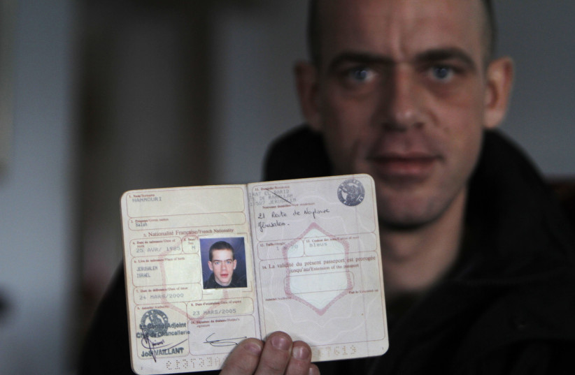 Salah Hamouri shows his French passport during an interview with Reuters in the neighbourhood of Dahiyet al-Barid, December 19, 2011 (photo credit: REUTERS/MOHAMAD TOROKMAN)