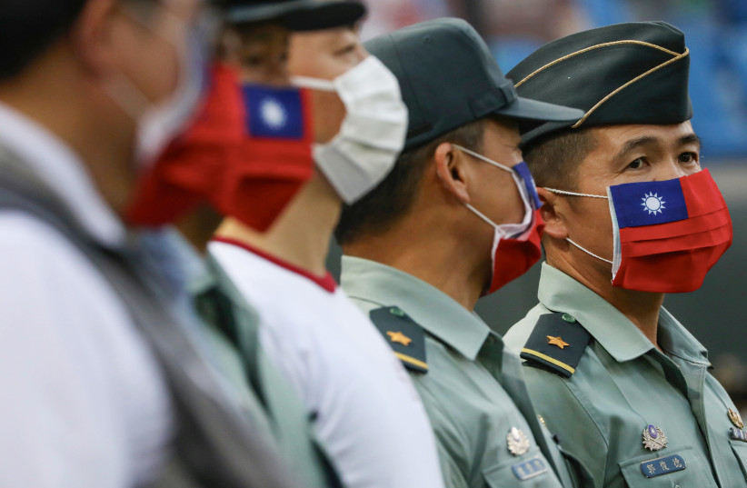Taiwanese Army representatives attend a baseball game with face masks adorned with the Taiwanese flag, May 7, 2020 (credit: REUTERS/ANN WANG)