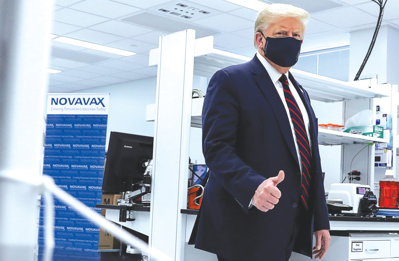 US PRESIDENT Donald Trump tours a pharmaceutical manufacturing plant, amid scientific concern about White House pressure to approve a vaccine before it is proven safe and effective. (photo credit: CARLOS BARRIA / REUTERS)
