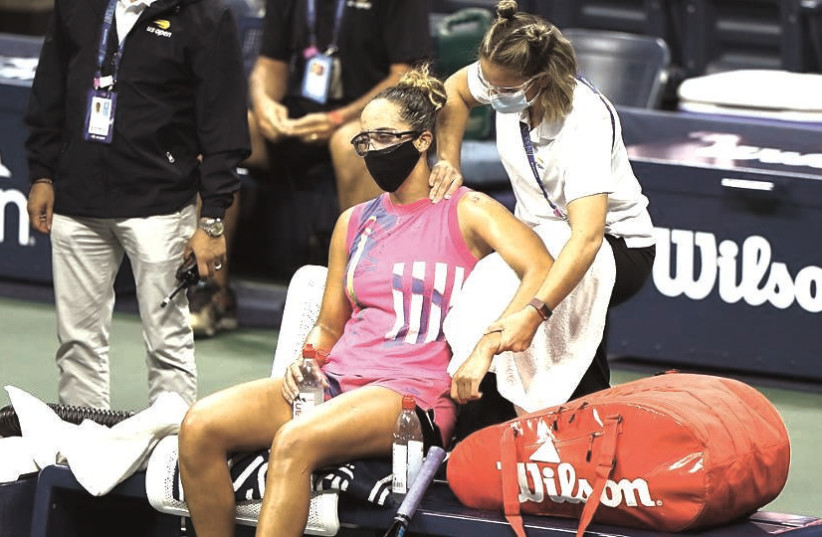 A MASKED Madison Keys receives courtside treatment during her first-round match last week at the decidedly different mid-pandemic 2020 US Open in New York (photo credit: USTA/COURTESY)