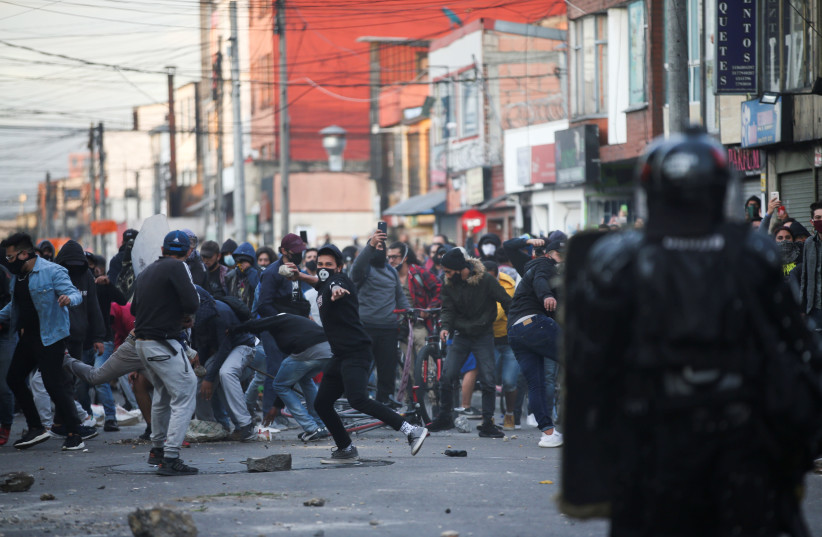 Protesters clash with police after a man, who was detained for violating social distancing rules, died from being repeatedly shocked with a stun gun by officers, according to authorities, in Bogota, Colombia September 9, 2020. (credit: LUISA GONZALEZ/REUTERS)