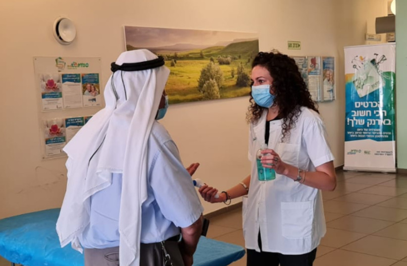 Azrieli Faculty of Medicine student assists a resident of Nazareth in a local clinic  (photo credit: BAR ILAN UNIVERSITY)