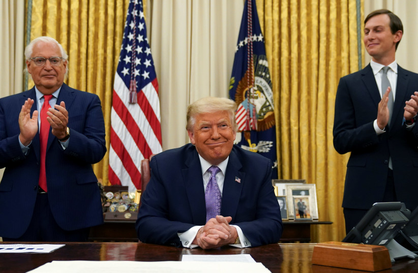 Flanked by US Ambassador to Israel David Friedman and White House senior adviser Jared Kushner, President Donald Trump announces a peace deal between Israel and the United Arab Emirates from the Oval Office of the White House in Washington on August 13, 2020.  (credit: KEVIN LAMARQUE/REUTERS)