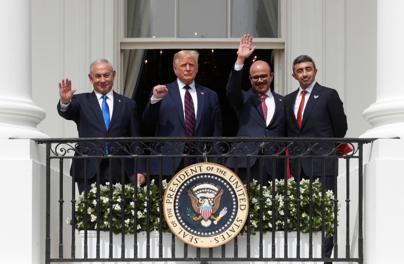 L to R: Israel's Prime Minister Benjamin Netanyahu, U.S. President Donald Trump, Bahrain’s Foreign Minister Abdullatif Al Zayani and United Arab Emirates (UAE) Foreign Minister Abdullah bin Zayed wave and gesture from the White House balcony after a signing ceremony for the Abraham Accords. Septembe (photo credit: REUTERS/TOM BRENNER)