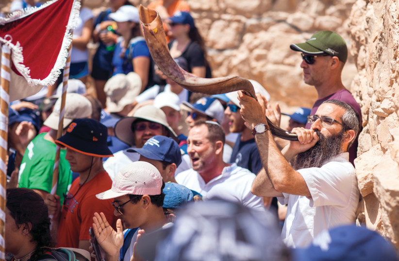JNF-USA supporters sound the shofar on top of the ancient Jewish fortress of Masada in 2019. (photo credit: JNF USA)