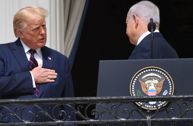 President Donald Trump talks to Israeli Prime Minister Benjamin Netanyahu from the Truman Balcony at the White House during the signing ceremony of the Abraham Accords, Sept. 15, 2020 (photo credit: SAUL LOEB/AFP VIA GETTY IMAGES/JTA)
