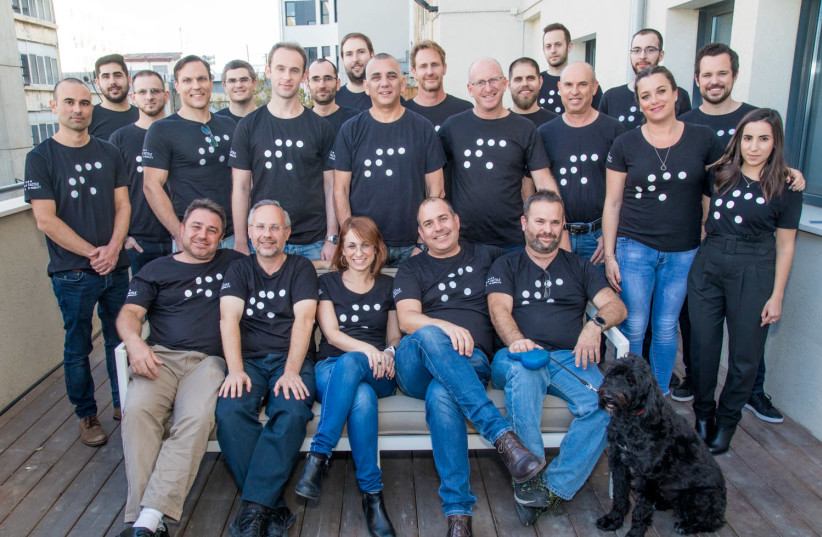Tactile Mobility co-founder Boaz Mizrachi (first row, first on the left) with the team that made the recent cooperation with BMW a reality (photo credit: ALEX FRAGMENT)