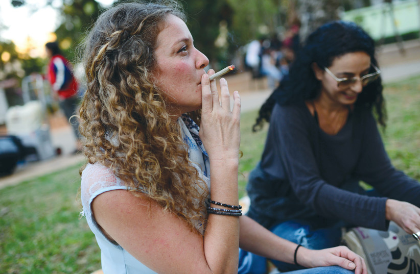 TEL AVIV residents partake in a joint in the city’s Meir Park.  (photo credit: TOMER NEUBERG/FLASH90)
