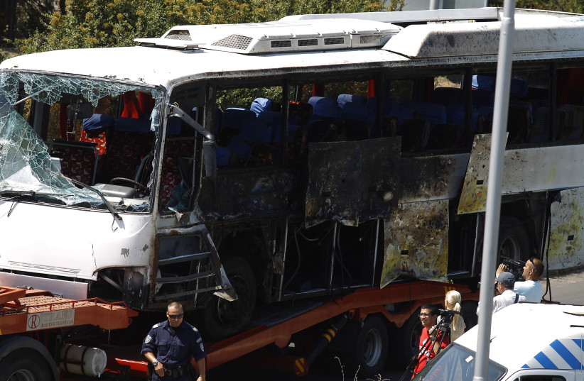 A truck carries a bus, that was damaged in a bomb blast on Wednesday, outside Burgas Airport, about 400km (248miles) east of Sofia July 19, 2012 (photo credit: REUTERS/STOYAN NENOV)