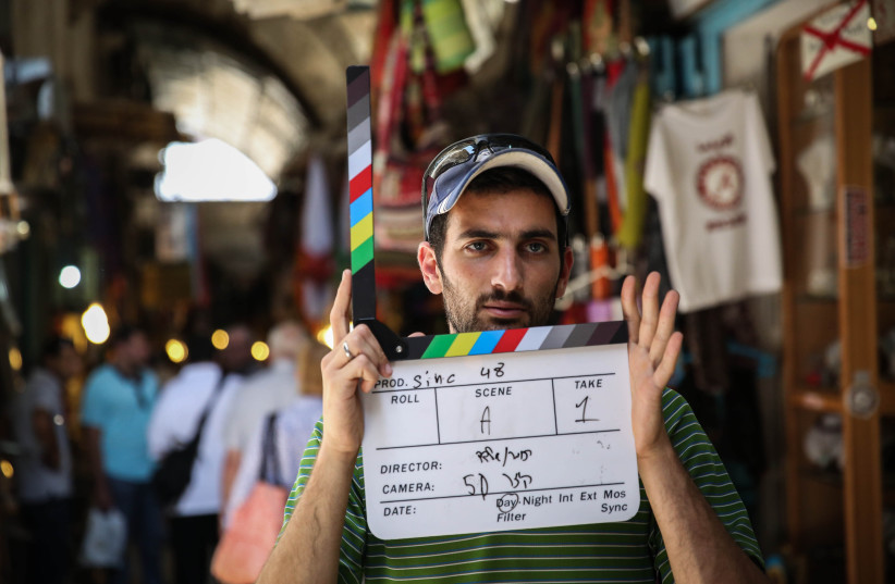 Young Israeli film makers seen producing a short film in the market in Jerusalem's Old City on June 19, 2014. (photo credit: HADAS PARUSH/FLASH90)