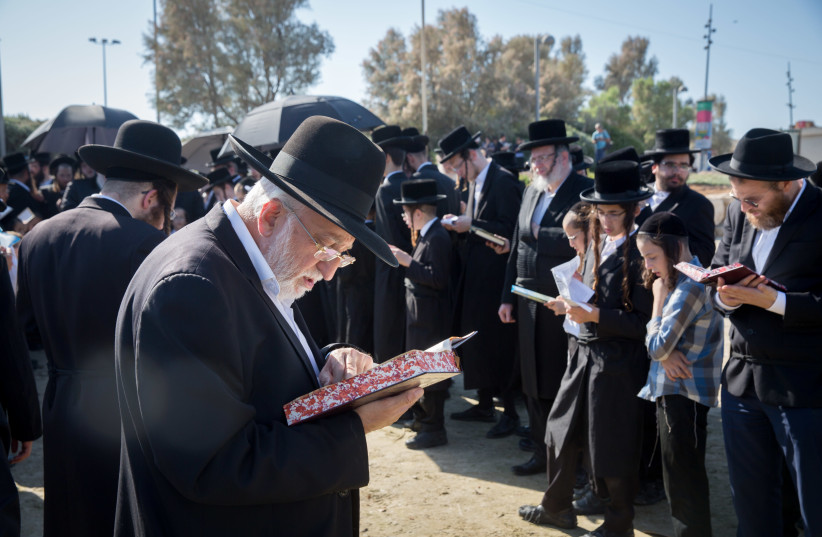 Ultra-Orthodox Jewish men arrive to pray on the banks of the Yarkon River in Tel Aviv during the ritual of Tashlich on October 07, 2019. (photo credit: FLASH90)