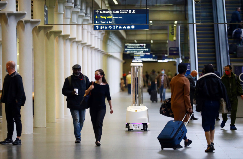 An ultraviolet (UV) robot designed to significantly reduce the risk of hospital acquired infections cleans St Pancras International station in London (photo credit: HANNAH MCKAY/ REUTERS)