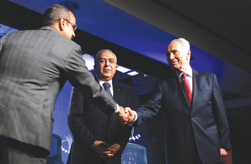 BAHRAIN’S CROWN Prince Salman bin Hamad Al-Khalifa (left) shakes hands with Shimon Peres as former PA prime minister Salam Fayyad looks on, at the Clinton Global Initiative in New York in 2010.  (photo credit: LUCAS JACKSON/REUTERS)