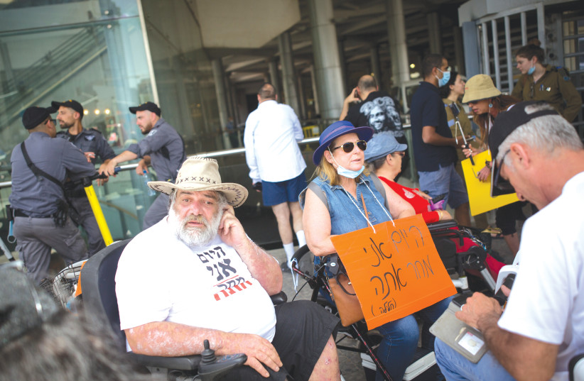 Disabled activists block the Azrieli Junction in Tel Aviv in May. (photo credit: MIRIAM ALSTER/FLASH90)