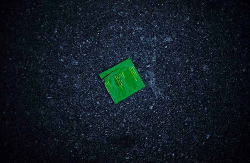 An empty condom wrapper lies on the street in Havana, Cuba, August 27, 2018. (credit: REUTERS)