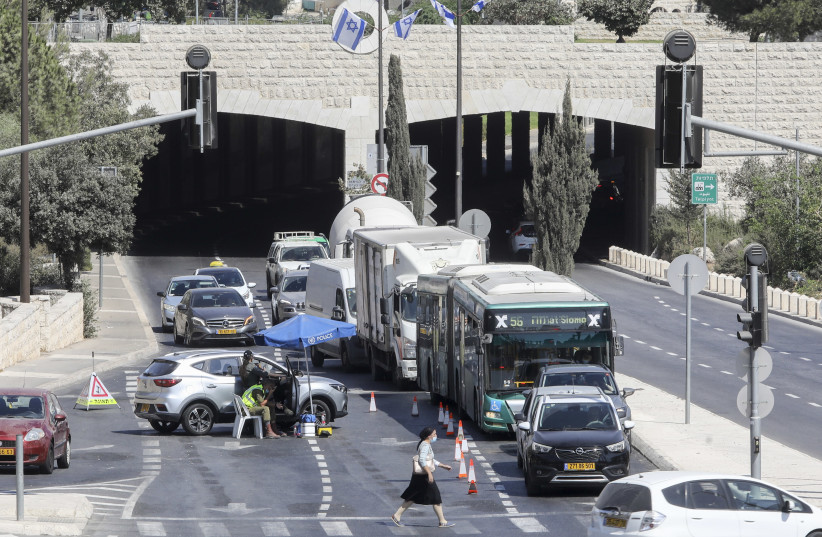 Traffic is seen backed up at a checkpoint in Jerusalem, during Israel's second coronavirus lockdown, September 2020. (photo credit: MARC ISRAEL SELLEM)