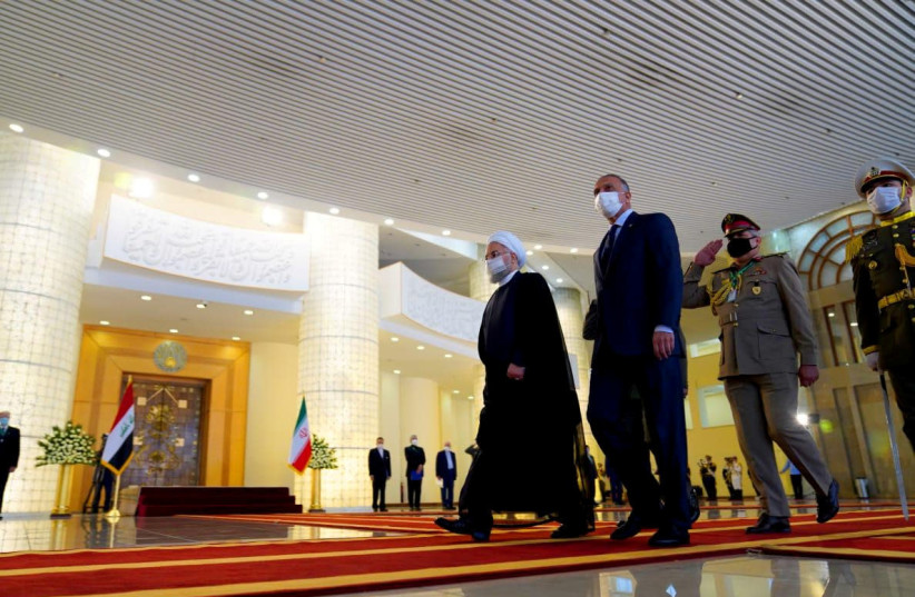 Iranian President Hassan Rouhani welcomes Iraqi Prime Minister Mustafa al-Kadhimi as they wear protective masks, in Tehran, Iran, July 21, 2020. (photo credit: IRAQI PRIME MINISTER MEDIA OFFICE/HANDOUT VIA REUTERS)