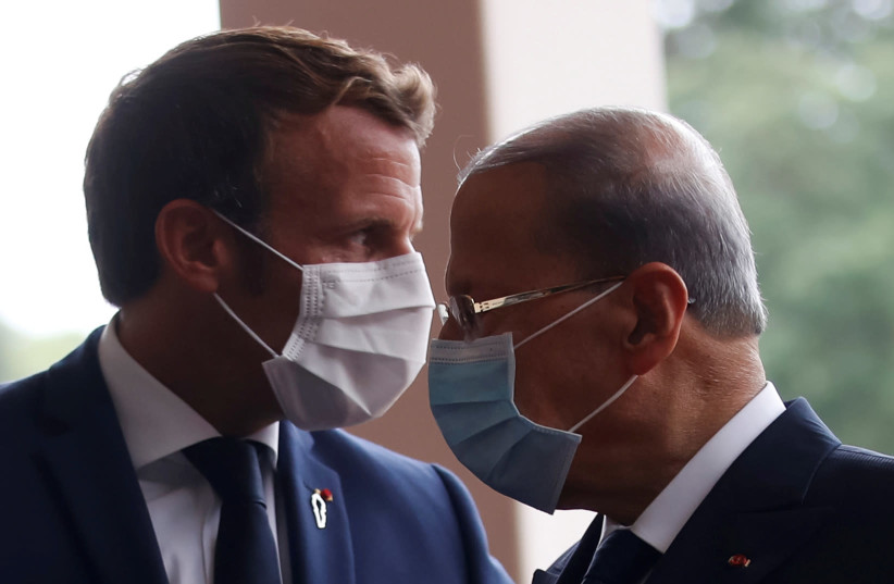 French President Emmanuel Macron and Lebanon's President Michel Aoun wear face masks as they arrives to attend a meeting at the presidential palace in Baabda, Lebanon September 1, 2020. (photo credit: REUTERS/GONZALO FUENTES/POOL)