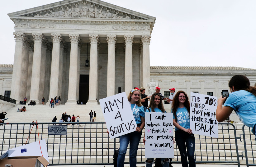 Protestors demonstrate outside the US Supreme Court after President Donald Trump announced US Court of Appeals Judge Amy Coney Barrett as his nominee to fill the Supreme Court seat left vacant by the death of Justice Ruth Bader Ginsburg, in Washington, US, September 26, 2020. (photo credit: REUTERS/JAMES LAWLER DUGGAN)