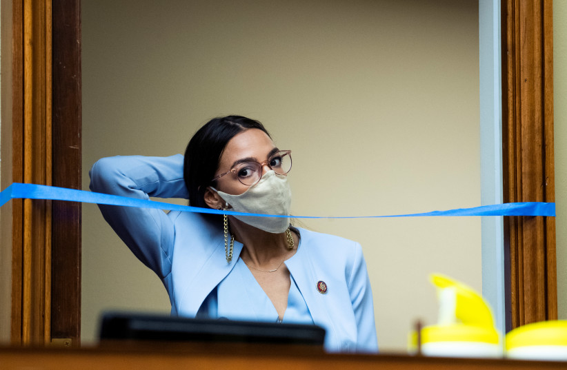 Rep. Alexandria Ocasio-Cortez, D-NY, arrives as Postmaster General Louis DeJoy testifies during the House Oversight and Reform Committee hearing on Monday, August 24, 2020. (photo credit: TOM WILLIAMS/POOL VIA REUTERS)