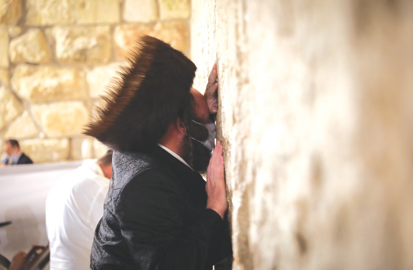 SLIHOT’ PRAYERS at the Kotel on Yom Kippur Eve. This year, we have so very much to think about, and given the restrictions in the way we celebrate, so much time to do that thinking. (credit: YONATAN SINDEL/FLASH90)