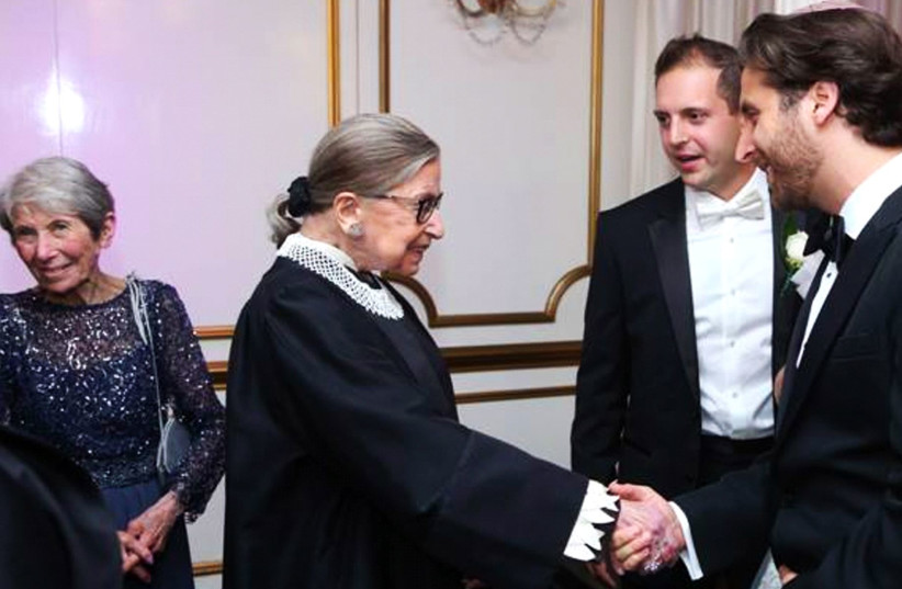 Justice Ruth Bader Ginsburg shakes hands with the author, Rabbi Avram Mlotek, at an Orthodox Jewish wedding in 2016. (photo credit: COURTESY OF MLOTEK)