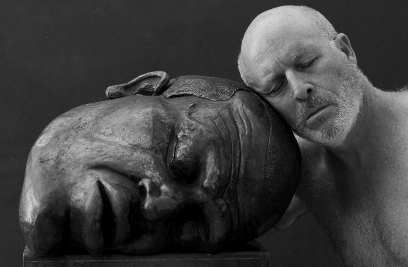 Israeli sculptor Dan Reisner pictured next to his rendering of George Floyd (photo credit: RON KEDMI)
