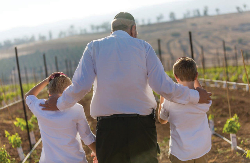 A WINE heritage passed down over 170 years. Winemaking grandfather, the late Moshe Shor, showing his grandchildren a newly planted vineyard. (photo credit: Courtesy)