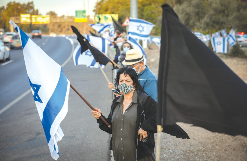 PROTESTERS DEMONSTRATE against Prime Minister Benjamin Netanyahu, on Highway 1 between Jerusalem and Tel Aviv, on October, 2020. (photo credit: NATI SHOHAT/FLASH90)