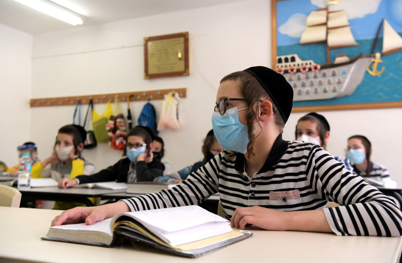 Ultra-Orthodox children wearing face masks at their school in the city of Rehovot, May 24, 2020 (photo credit: YOSSI ZELIGER/FLASH90)