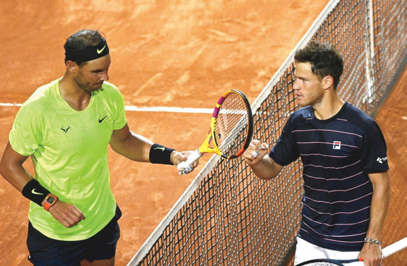 DIEGO SCHWARTZMAN (right) and Spaniard Rafael Nadal meet at the net after the Jewish-Argentine won their quarterfinal match last month in Rome. The two face off today in the French Open semifinals (credit: REUTERS)