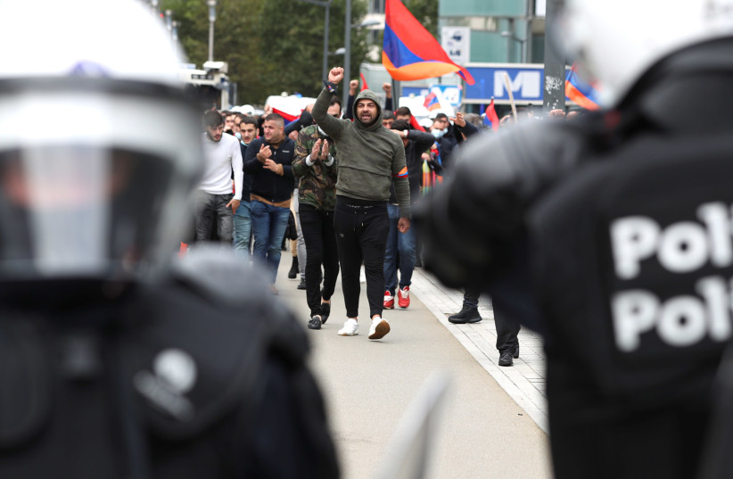 People supporting Armenia protest against the military conflict with Azerbaijan over the breakaway region of Nagorno-Karabakh, in Brussels, Belgium October 7, 2020 (photo credit: REUTERS/YVES HERMAN)