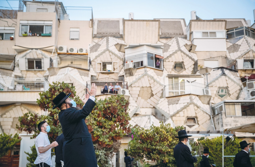 MEN PRAY outside the Ramot Polin Apartments in Jerusalem’s Ramot neighborhood last month.  (photo credit: YONATAN SINDEL/FLASH90)