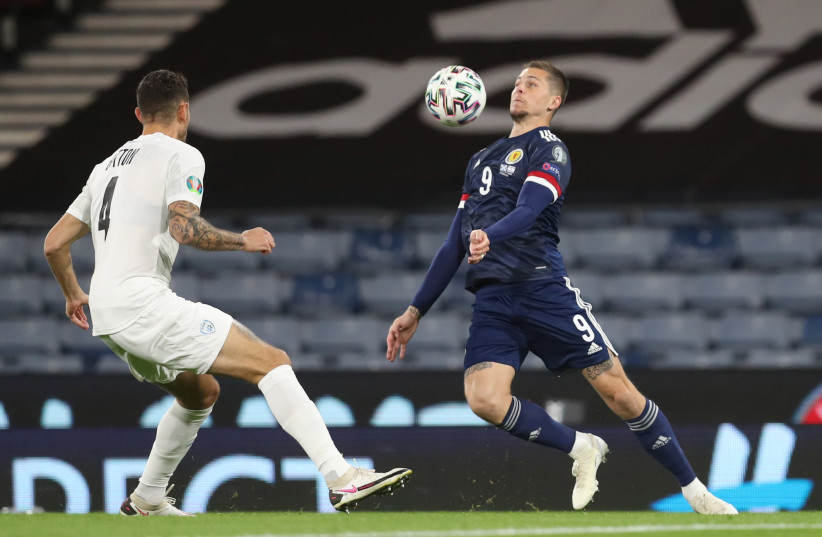 Euro 2020 Qualification Play off - Scotland v Israel - Hampden Park, Glasgow, Scotland, Britain - October 8, 2020 Scotland's Lyndon Dykes in action with Israel's Nir Bitton (photo credit: REUTERS)