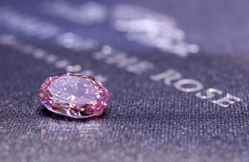 The Spirit of the Rose, the world's largest vivid purple-pink diamond, is seen on display before an upcoming Geneva auction, during a Sotheby's preview in Hong Kong, China October 12, 2020. (photo credit: TYRONE SIU/ REUTERS)