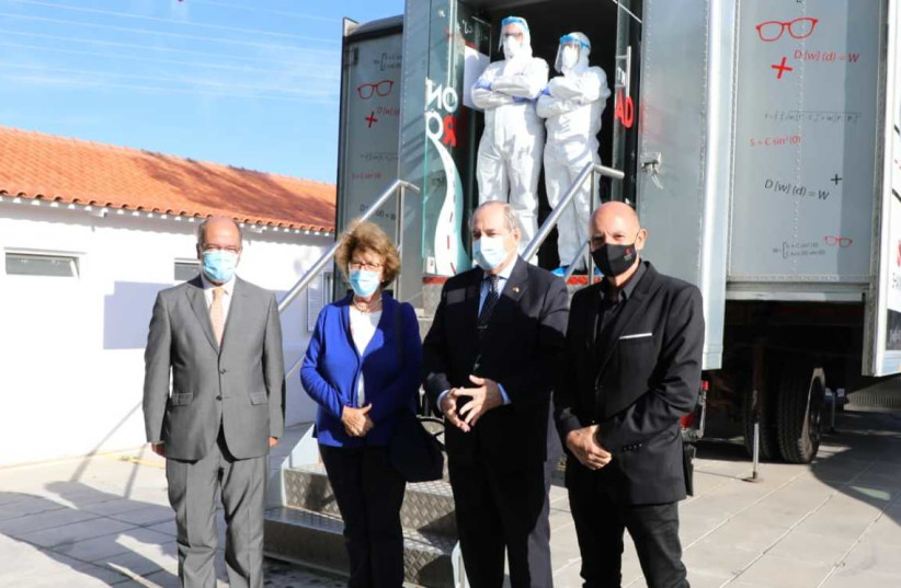 Officials & lab technicians at the dedicated van (photo credit: Courtesy)