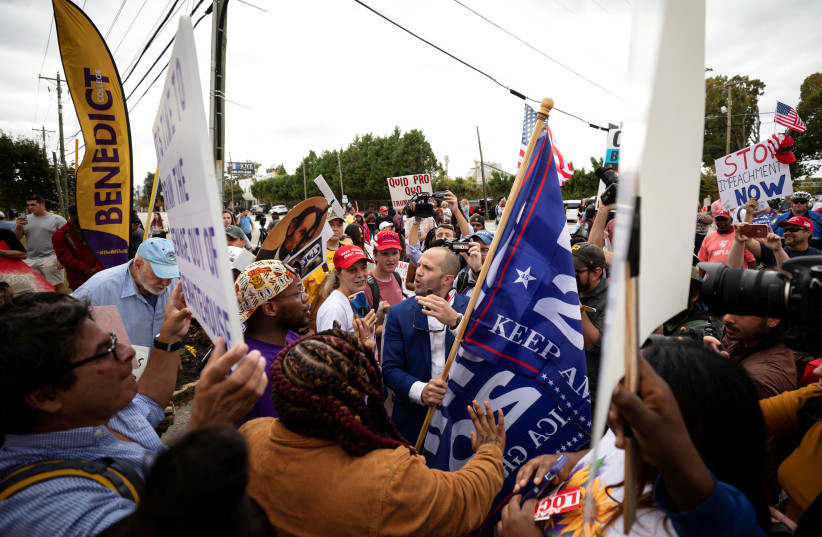 Protesters and supporters of U.S. President Donald Trump clash in front of Benedict College as the president spoke at the 2019 Second Step Presidential Justice Forum at the college in Columbia, South Carolina, U.S. October 25, 2019. (photo credit: REUTERS/SAM WOLFE)
