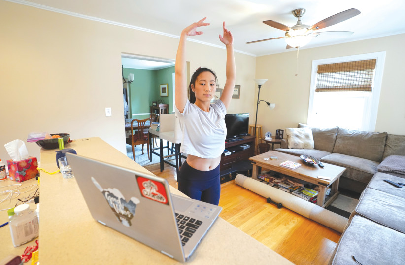 THE CLASSROOM entered the home and different models of hybrid learning were created. Allison Vernon, a ballet major at the University of Utah, continues her dance curriculum online at her home in Arlington,Virginia, in April. (photo credit: KEVIN LAMARQUE/REUTERS)