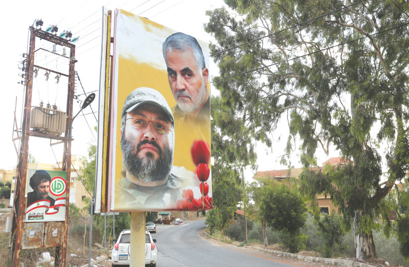 A POSTER depicting assassinated Hezbollah military commander Imad Moughniyeh and IRGC Quds Force Maj.-Gen. Qasem Soleimani hangs in Lebanon in September. (photo credit: AZIZ TAHER/REUTERS)