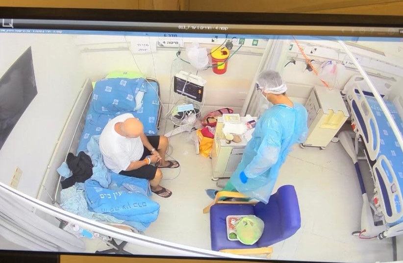 Family member visiting a coronavirus patient at Hadassah Ein Kerem Hospital, October 2020. (photo credit: HADASSAH UNIVERSITY MEDICAL CENTER)