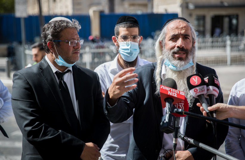Uri Pollack, the father of Yitzhak Pollack, 27, who was arrested during the dispersal of his sister's wedding in Giv'at Ze'ev last night, speaks with the media outside the police station in Jerusalem, October 15, 2020. (photo credit: YONATAN SINDEL/FLASH90)
