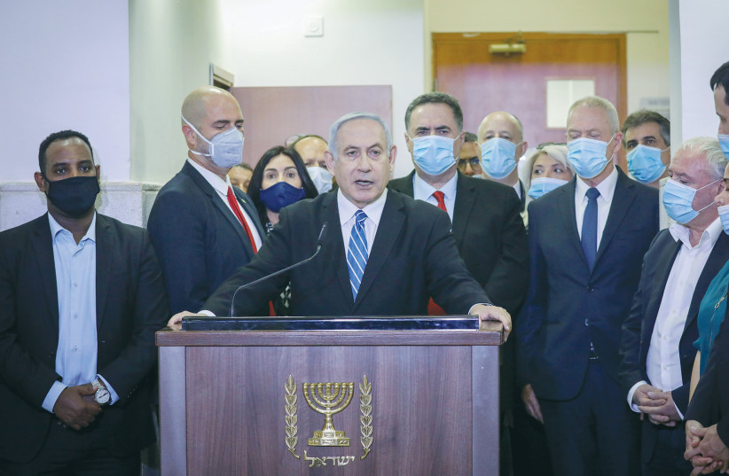 PRIME MINISTER Benjamin Netanyahu speaks before entering the court room where he is facing a trial for alleged corruption crimes, in Jerusalem, on May 24. (photo credit: YONATAN SINDEL/REUTERS)