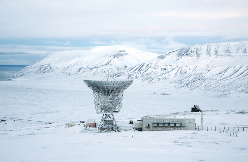 A RADAR DISH sits above the European Incoherent Scatter Scientific Association facility in Breinosa, Norway, in 2015.  (photo credit: REUTERS)