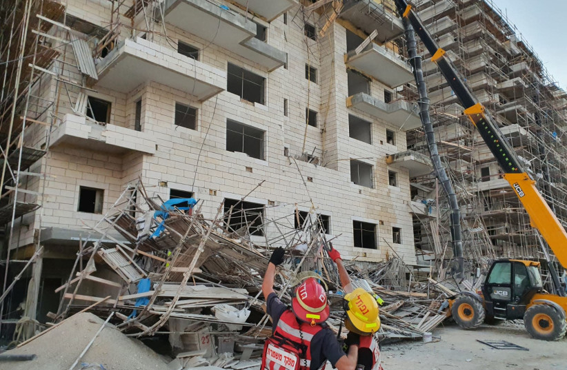 Firefighters work to rescue construction workers trapped under collapsed scaffolding, Oct. 21, 2020 (photo credit: ISRAEL FIRE AND RESUCE SERVICES)