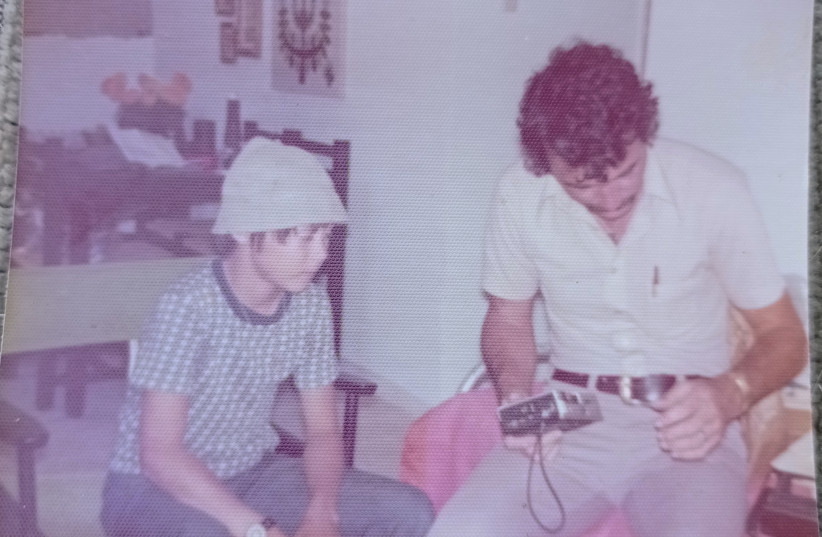 Arieh O'Sullivan and his father Efraim listen to radio news reports during the Yom Kippur War, October 1973. (photo credit: ARIEH O’SULLIVAN)
