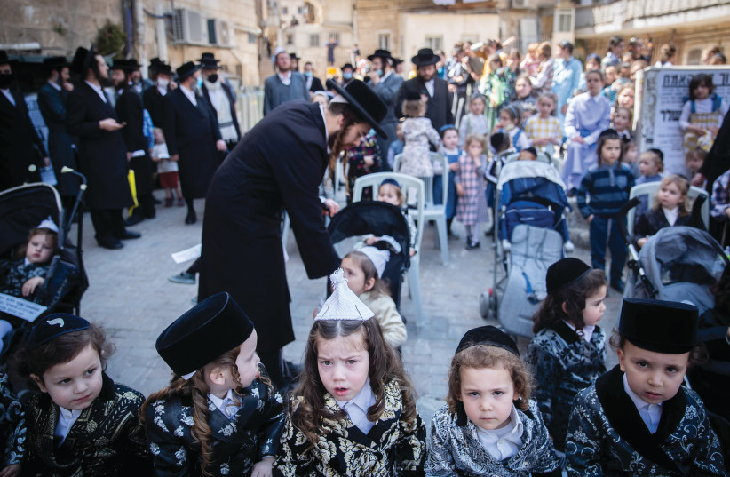 Haredi men and their children protest government restrictions barring them from reaching Mount Meron on Lag Ba’omer, in Jerusalem’s Mea She’arim neighborhood on May 10, 2020. (photo credit: YONATAN SINDEL/FLASH90)