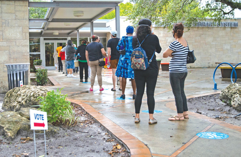 Floridians stand in line to vote on first day of early voting for the general election in Miami, on Monday. (photo credit: DAVID SANTIAGO/MIAMI HERALD/TNS)